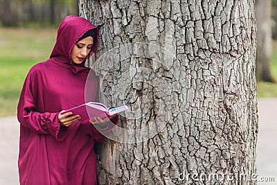 Confident Arab businessman smiling and walks of Dubai. Arab Business vumen hijab is in the streets against the Stock Photo