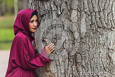 Confident Arab businessman smiling and walks of Dubai. Arab Business vumen hijab is in the streets against the Stock Photo