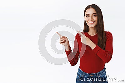 Confident, assertive pretty modern brunette girl in red sweater promoting offer, advice link or recommend shop, product Stock Photo