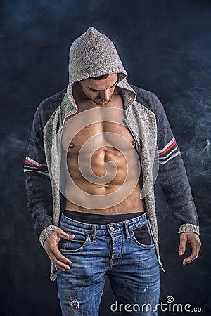 Confident, attractive young man with open vest on Stock Photo