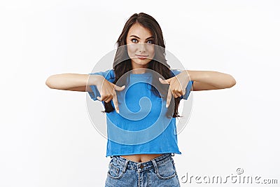 Confident brunette girl showing team members great link gain new skills, pointing fingers down, inviting join courses or Stock Photo