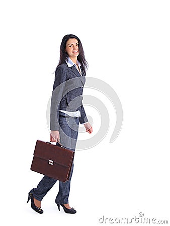 Confident business woman going and holding a brief Stock Photo