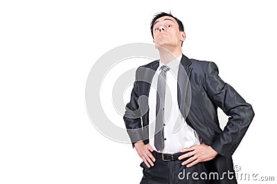 Confident businessman keeping hands on waist and looking arrogant Stock Photo