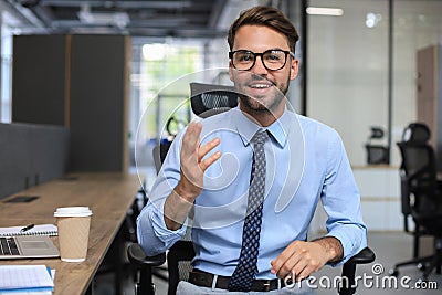 Confident businessman looking at camera talking about company strategy and business plan, explaining corporate success Stock Photo