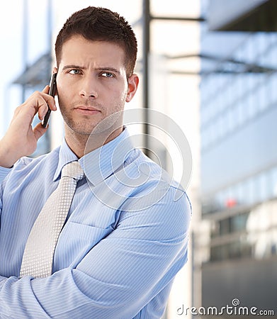 Confident businessman using mobile outdoors Stock Photo