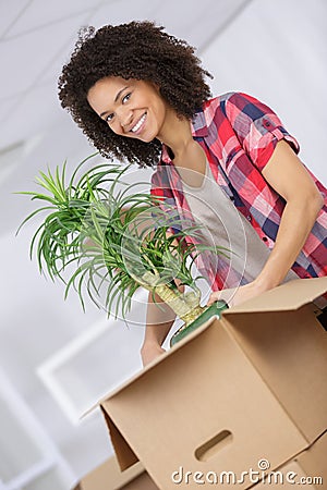 Confident businesswoman carrying box to new office Stock Photo