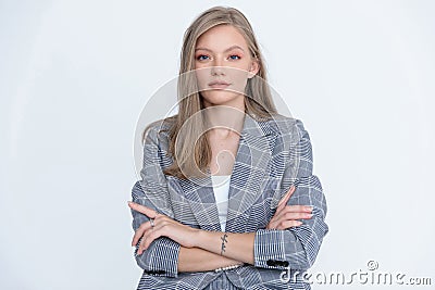 Confident businesswoman holding her arms crossed and wearing suit Stock Photo