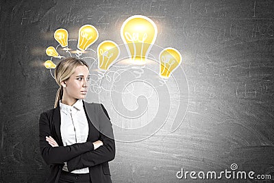 Confident businesswoman and many light bulbs Stock Photo