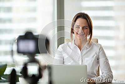 Confident businesswoman recording video course on camera Stock Photo