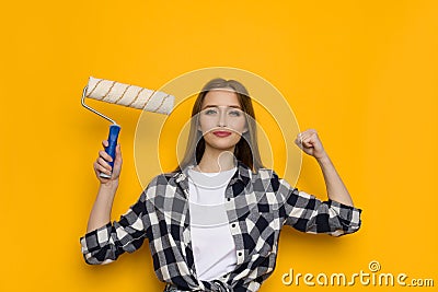 Confident Young Woman Is Holding Paint Roller Stock Photo