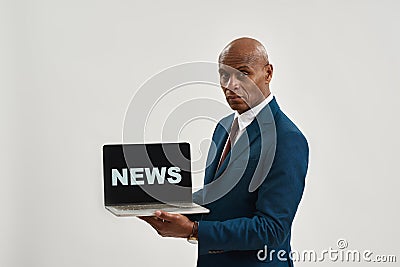 Confident ceo manager hold laptop with 'news' word Stock Photo