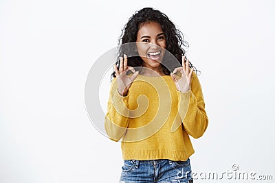 Confident cheerful young lucky african american girl with curly hairstyle, show okay, accepting gesture smiling happy Stock Photo