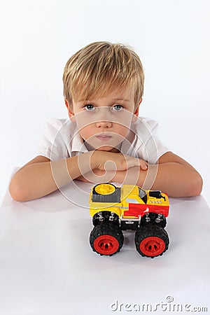 A confident child boy playing with a car toy Stock Photo