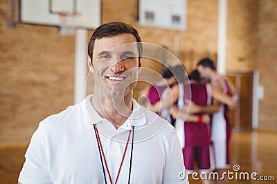 Confident coach standing in basketball court Stock Photo