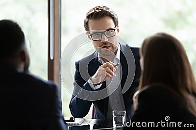 Confident businessman head meeting with colleagues in office boardroom Stock Photo