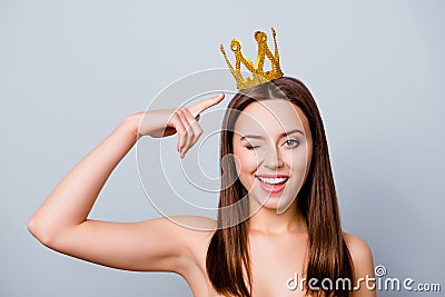 Confident cute beautiful young woman with a crown on her head is Stock Photo