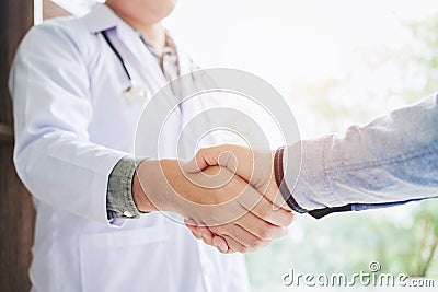 Confident Doctor shaking hands with patients talk in the hospit Stock Photo