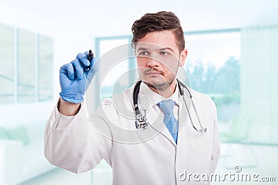 Confident doctor writing something in the air Stock Photo