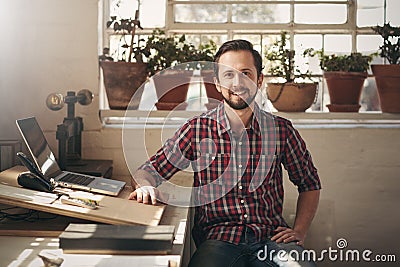 Confident entrepreneur designer sitting in his office space Stock Photo