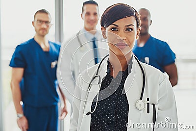 Confident female doctor in front of team Stock Photo