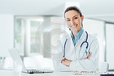 Confident female doctor at office desk Stock Photo