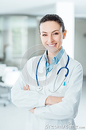 Confident female doctor posing in her office Stock Photo