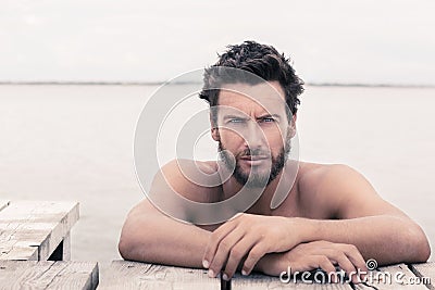 Confident Gorgeous Handsome Man with No Shirt at the Sea Stock Photo