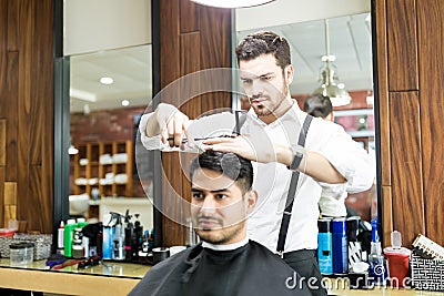 Hairstylist Focusing On Cutting Hair Of Customer In Salon Stock Photo