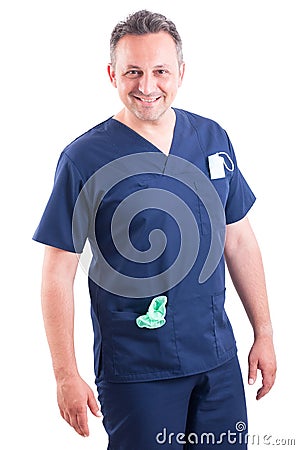 Confident and handsome doctor posing wearing blue scrubs Stock Photo