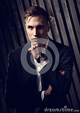Confident handsome man with strained look posing in blue fashion Stock Photo