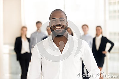 Happy african business coach corporate leader posing with diverse team Stock Photo