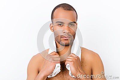 Confident harsh young mulatto nude man is standing on the pure w Stock Photo