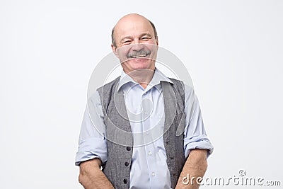 Confident hispanic mature man laughing and smiling Stock Photo