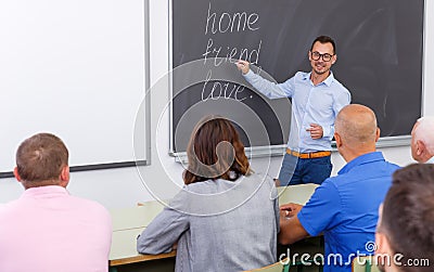 Confident lecturer talking to mixed age students Stock Photo