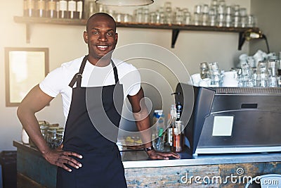 Confident male coffee house owner at counter Stock Photo