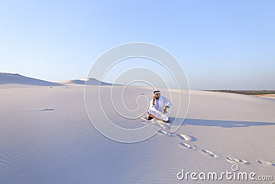 Confident male Emirate builder speaks on cellular with customer, Stock Photo