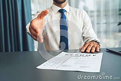 Confident man reach his hand for hand shake during job interview. Fervent Stock Photo