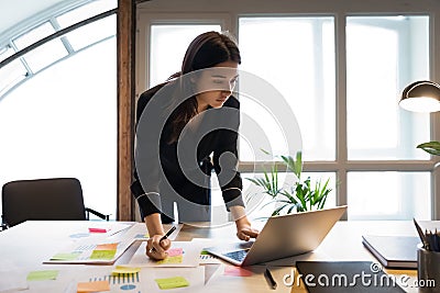 Confident millennial indian female business analyst preparing statistic report Stock Photo