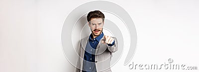 Confident and motivated businessman in suit need you, pointing finger at camera with encouraging face, choosing person Stock Photo