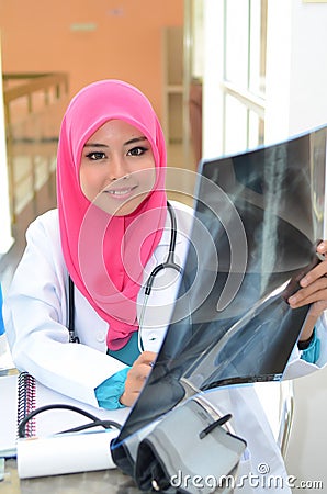 Confident Muslim doctor busy at hospital Stock Photo