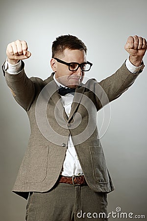 Confident nerd in eyeglasses and bow tie enjoying success Stock Photo