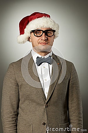 Confident nerd in Santa Claus hat and bow tie Stock Photo