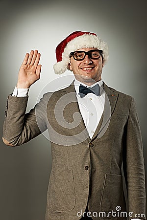 Confident nerd in Santa Claus hat and bow tie Stock Photo
