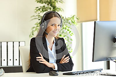 Confident office worker with headset looks at camera Stock Photo