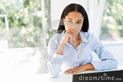 Confident pretty black businesswoman in modern office with copy space Stock Photo