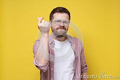 Confident resourceful man has found a solution to the problem, he snaps fingers in a satisfied manner and looks at the Stock Photo