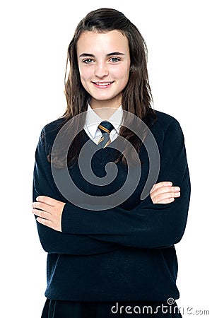 Confident schoolgirl posing with folded arms Stock Photo