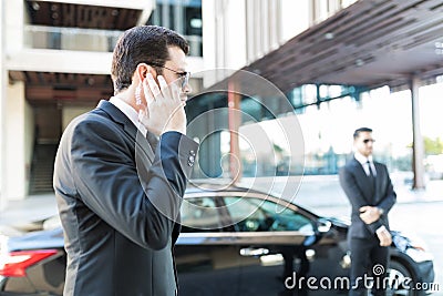 Bodyguard Getting Information About Arrival Of Boss Stock Photo