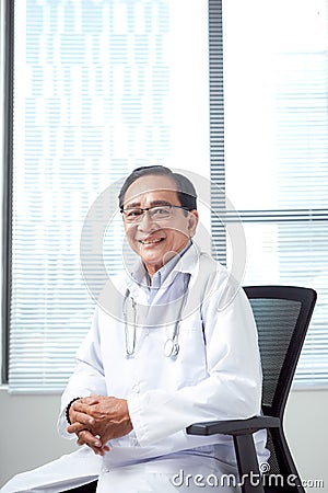 Confident senior citizen as competent doctor Stock Photo