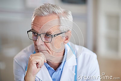 Confident senior doctor at office Stock Photo